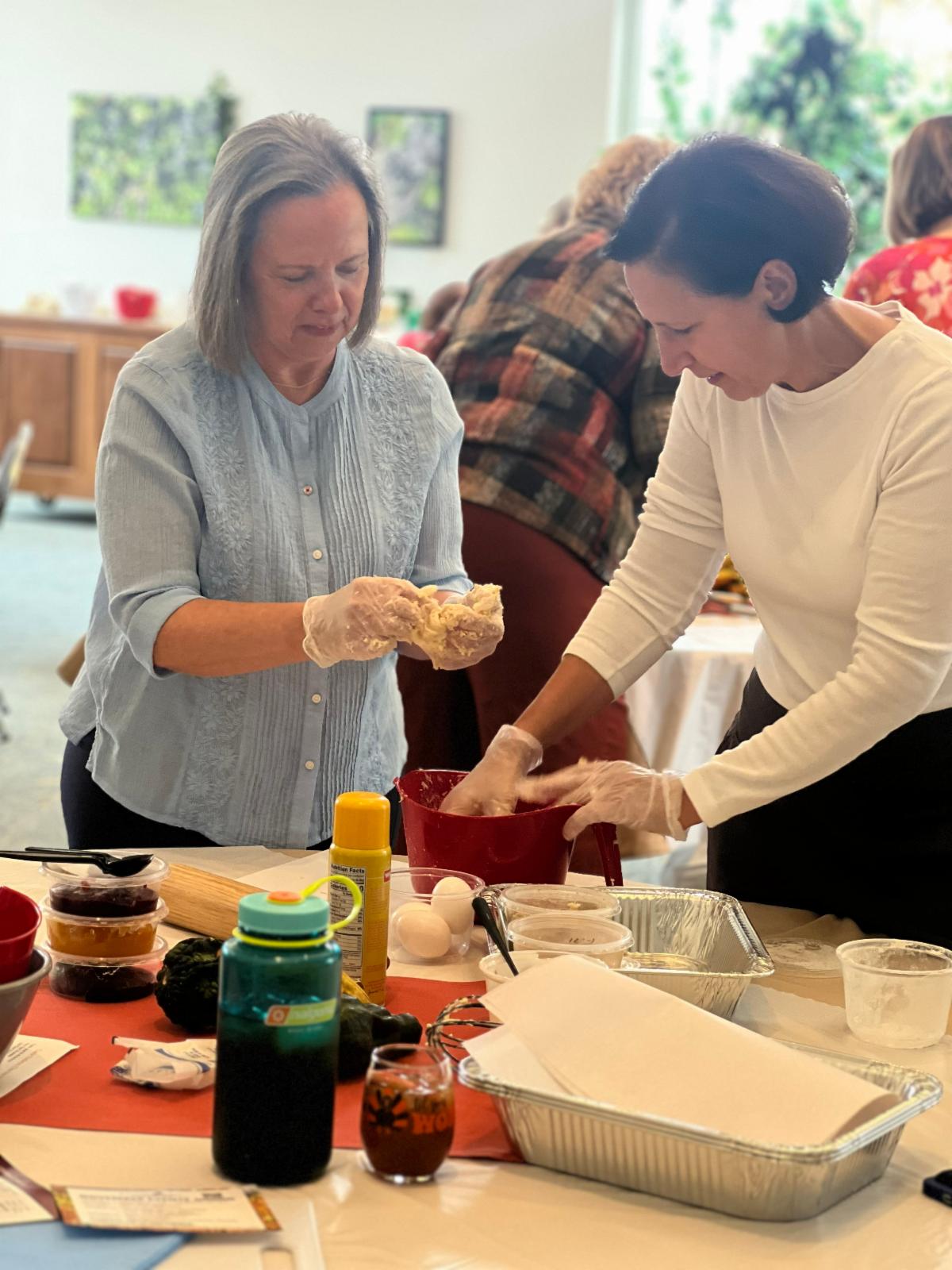 Two women making kiffles during a class at Clover Hill VIneyards & Winery