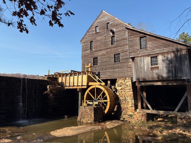 View of new waterwheel and forebay on south side of historic gristmill