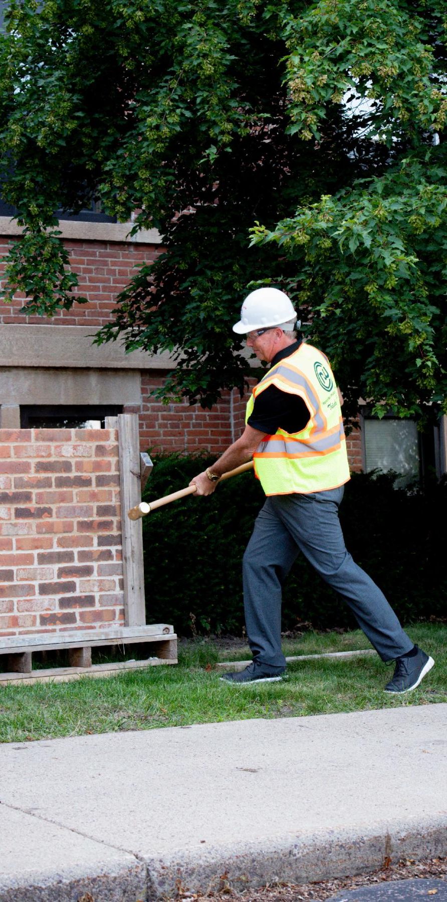 Scott Schmudlach takes a whack at the brick wall.