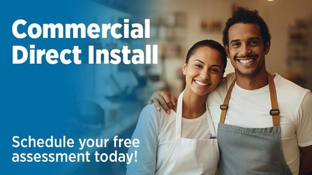 Woman and man standing next to each other wearing aprons and smiling. Text reads: Commercial Direct Install Schedule your free assessment today!