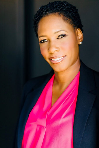 Image of a woman wearing a pink top and black jacket