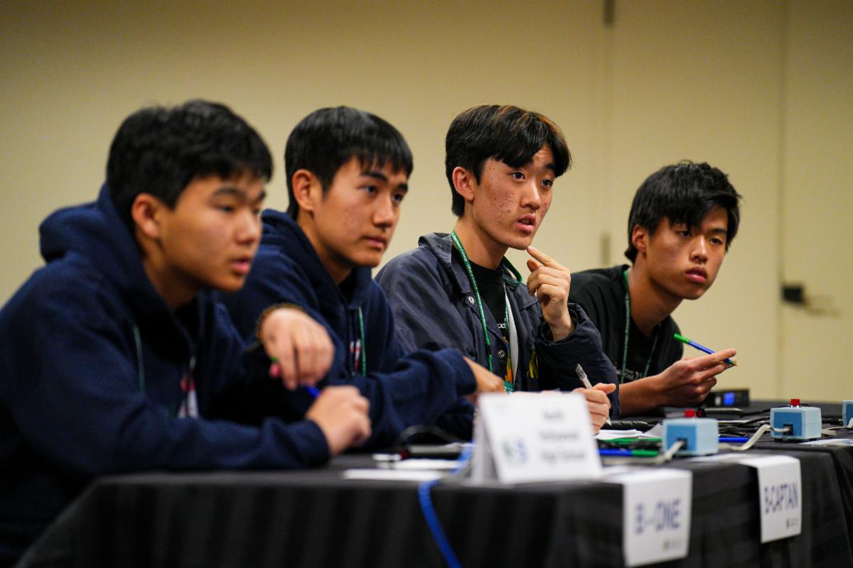 Four North Hollywood High School students seated at a competition table during the National Science Bowl®.