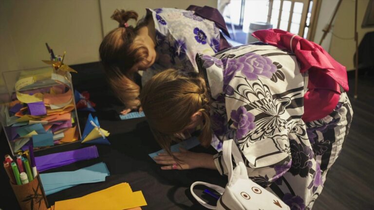Image of two ladies in traditional Japanese attire writing a note