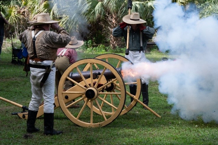 two people around a historic cannon