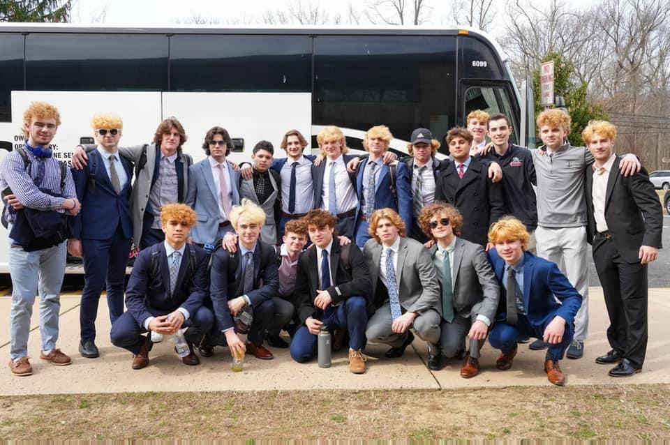 The Middletown North ice hockey team poses for a group photo outside the bus that took them to the NJSIAA Public B State Championship game at the Prudential Center in Newark.