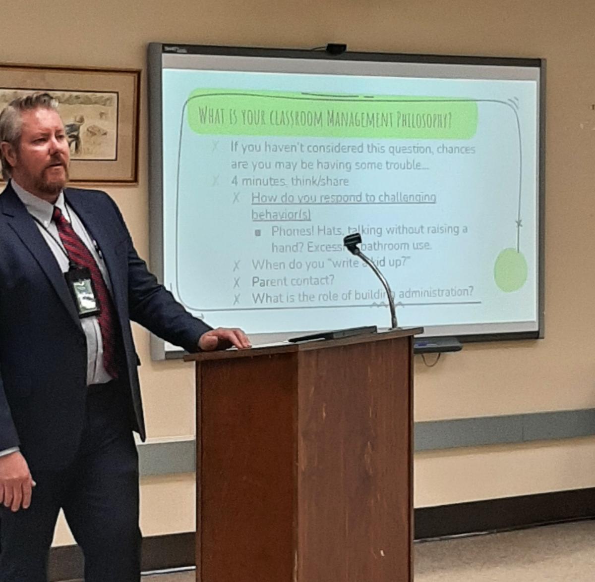 District Administrator James Rasmussen directs a presentation about classroom culture and educational philosophy.