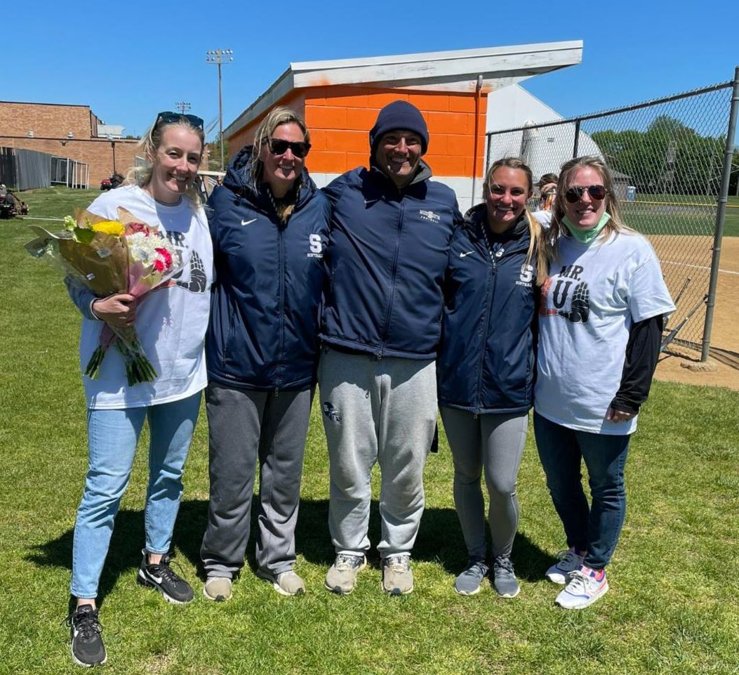 The High School South softball coaching staff poses with Rick Unterstein's daughters, Erin and Allison.