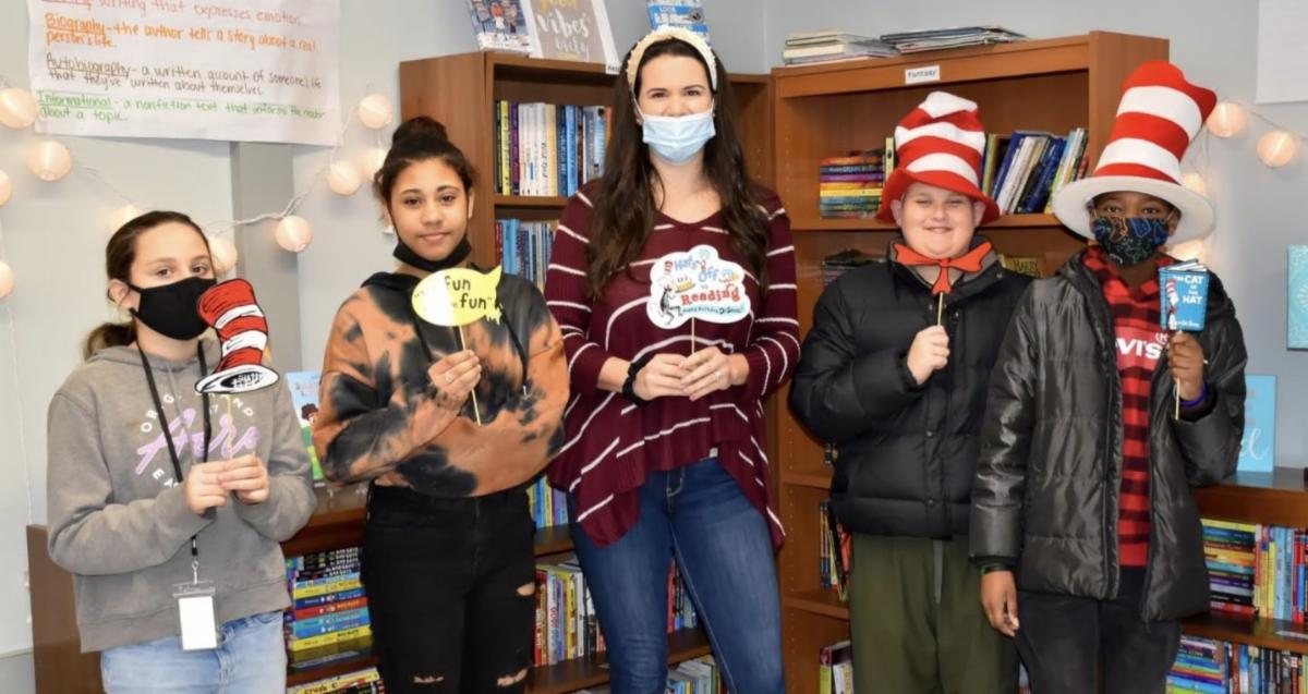 Elementary school students wear red and white swirled hats, as seen in the Dr. Seuss book "The Cat in the Hat," to celebrate Read Across America Day.