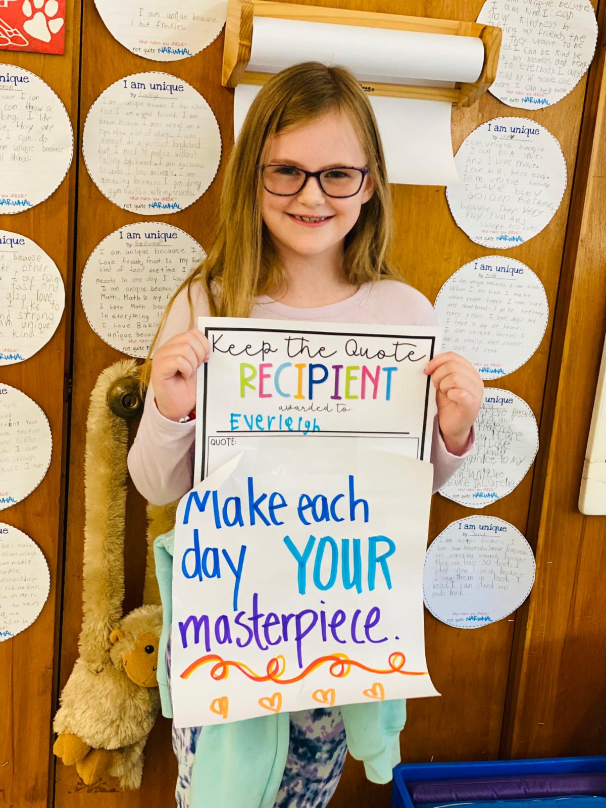 Middletown Village third grader, Everleigh, poses with the quote of the week after being honored by her teacher.