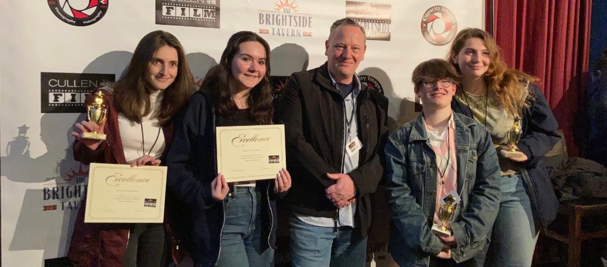High School South students pose with awards and their teacher Chris Corey at the Brightside Film Festival in Jersey City.