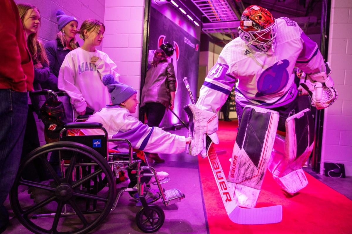 Nut Swamp student RJ Ferguson meets New Jersey Devils goaltender Vitek Vanicek.