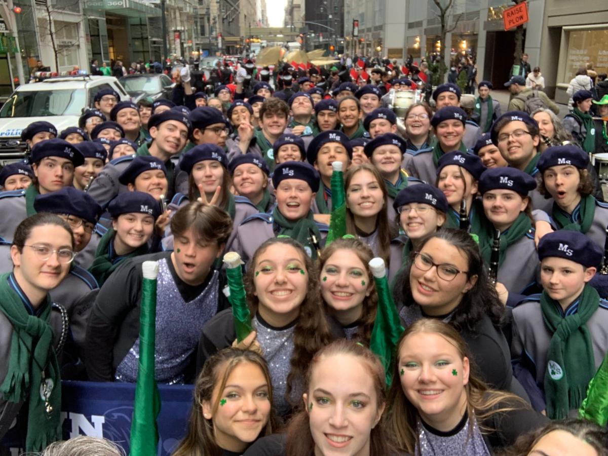 The High School South marching band poses for a group photo on the streets of New York City ahead of the annual St. Patrick's Day Parade.