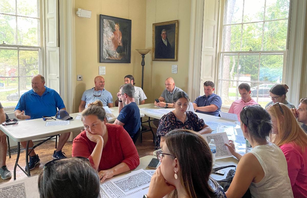 MTPS educators review source materials at the Marlpit House in the Middletown Village section of the community.