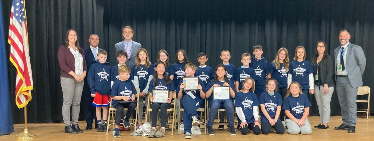 Lincroft Elementary's inaugural student council stands on a stage with Principal Dan Imbimbo, district administrators and board of education members.