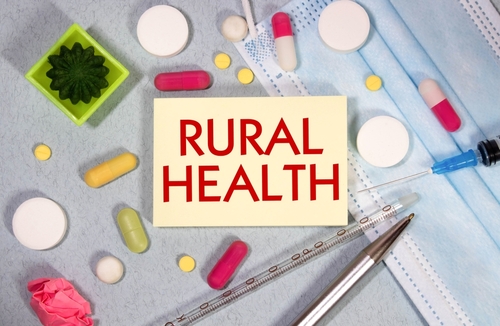 In the notebook is the text rural health_ next to a stethoscope_ pills and glasses.
