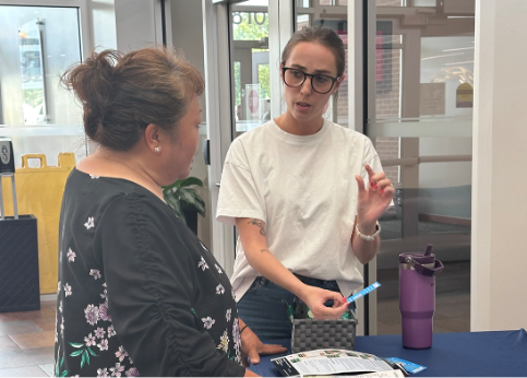 69Express staff talks to community member at the Overland Park Farmer’s Market