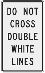 Overhead signage on U.S. 69 identifies the express lane boundary. Drivers should not cross the double white lines at this point.