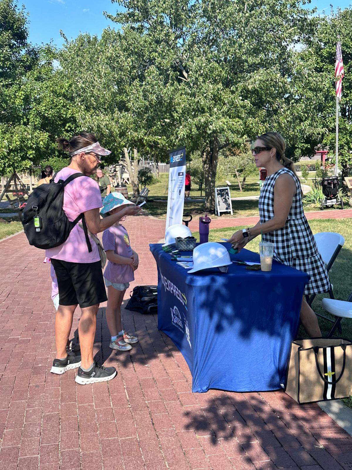 A 69Express staff member talks to a community member at a Deanna Rose Farmstead event.
