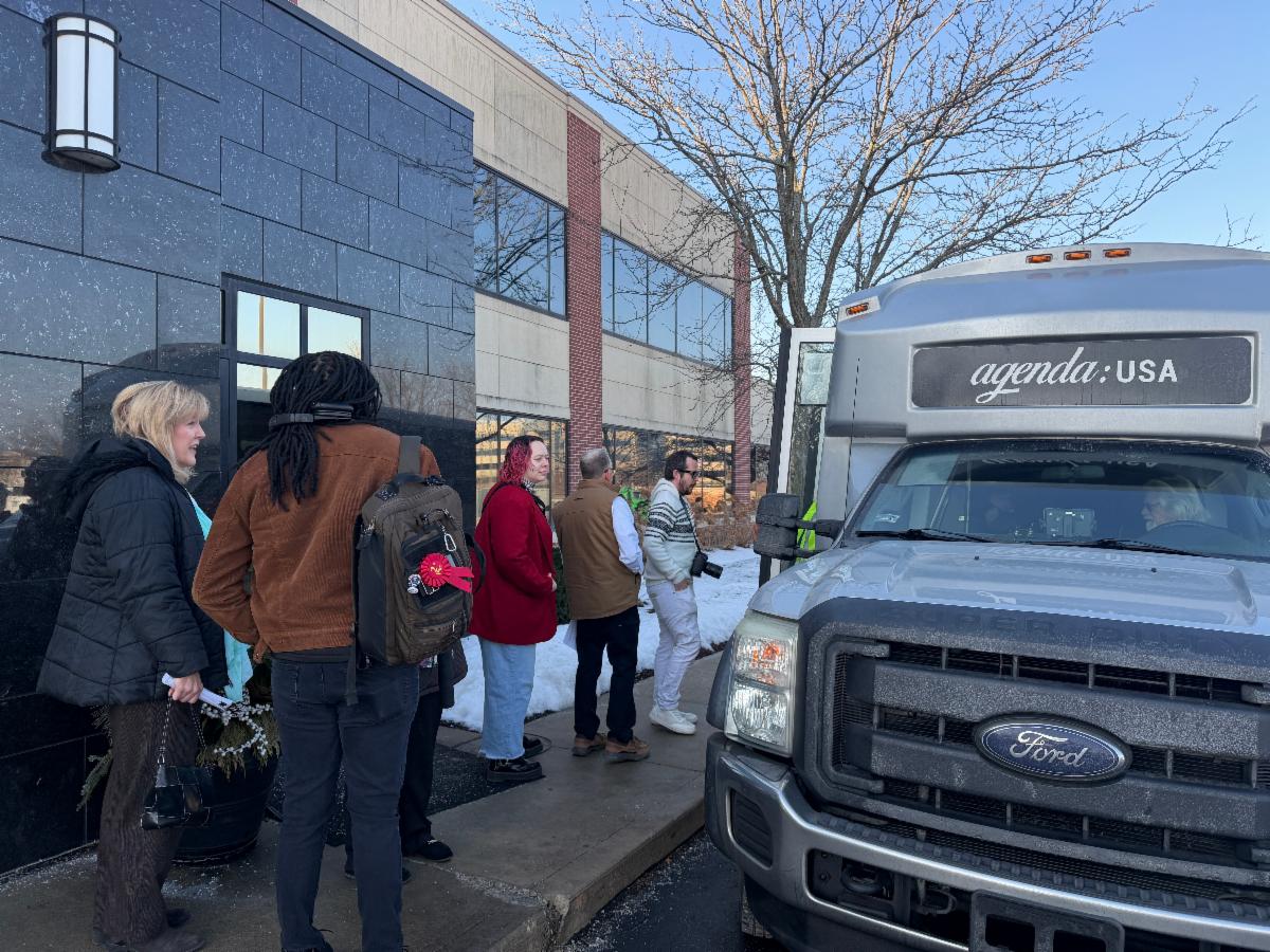 Media Day attendees load the bus for a drive-through tour of 69Express.
