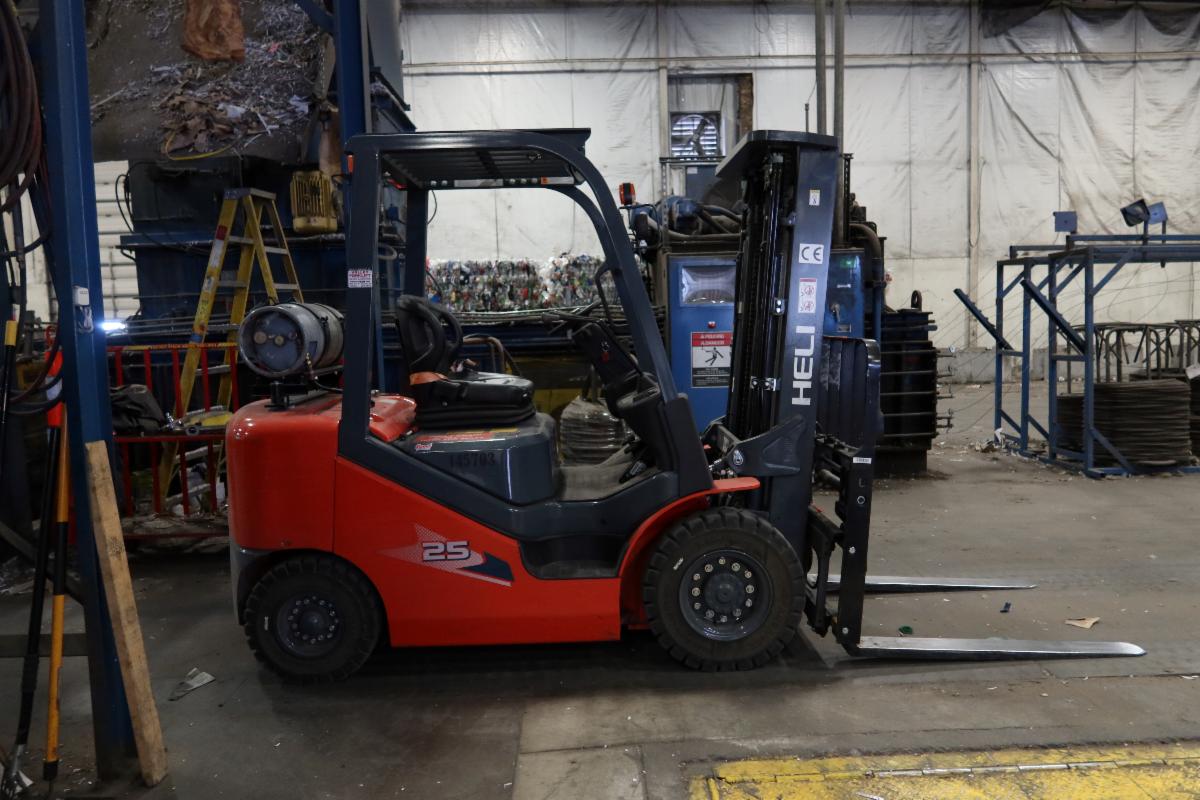 Small red forklift in a warehouse setting