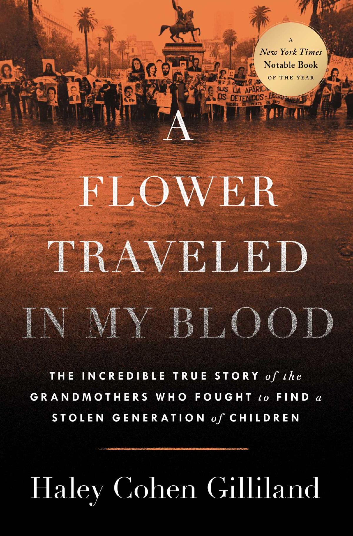 Book cover of A Flower Traveled in My Blood. The image on the cover is a large group of people holding signs with people's faces on them. The cover has a gold circle in the top right corner with the words A New York Times Notable Book of the Year.