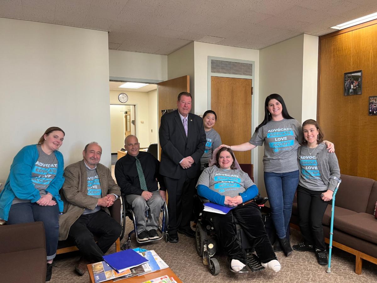 Group of people with disabilities wearing shirts that read, Advocate Educate Love Accept Spina Bifida Association NYS