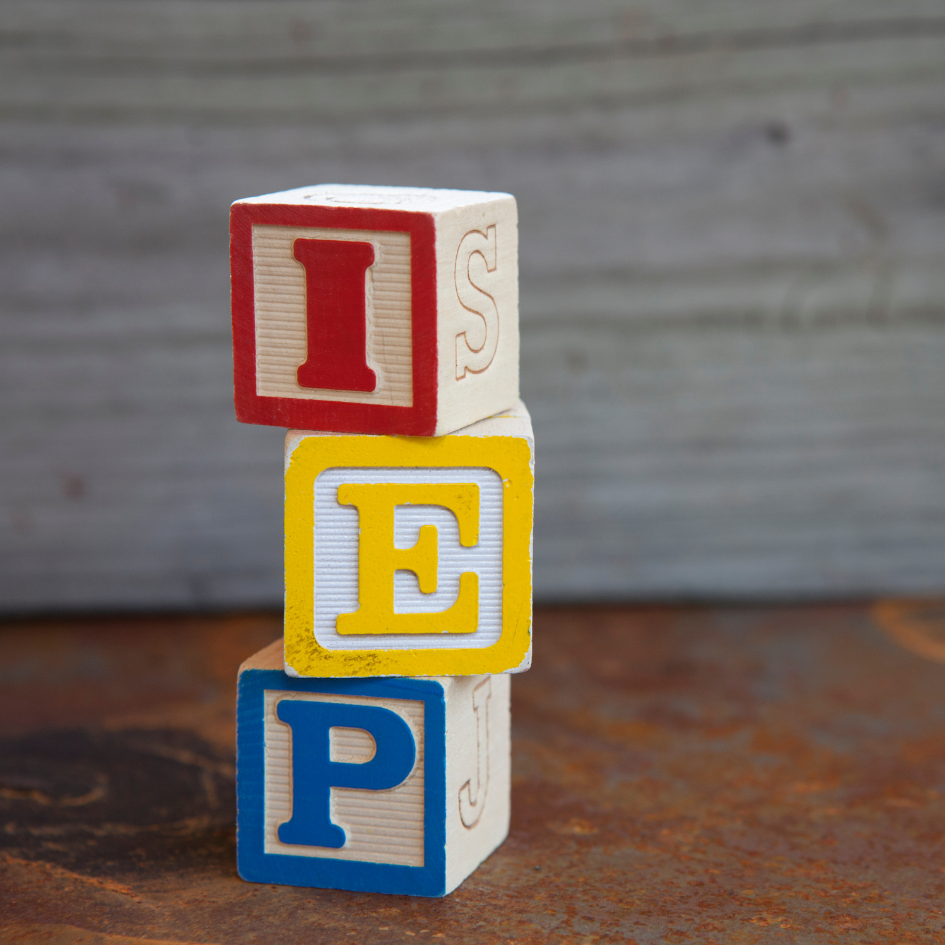 Image of 3 Toy wooden blocks stacked 3 high spelling IEP.