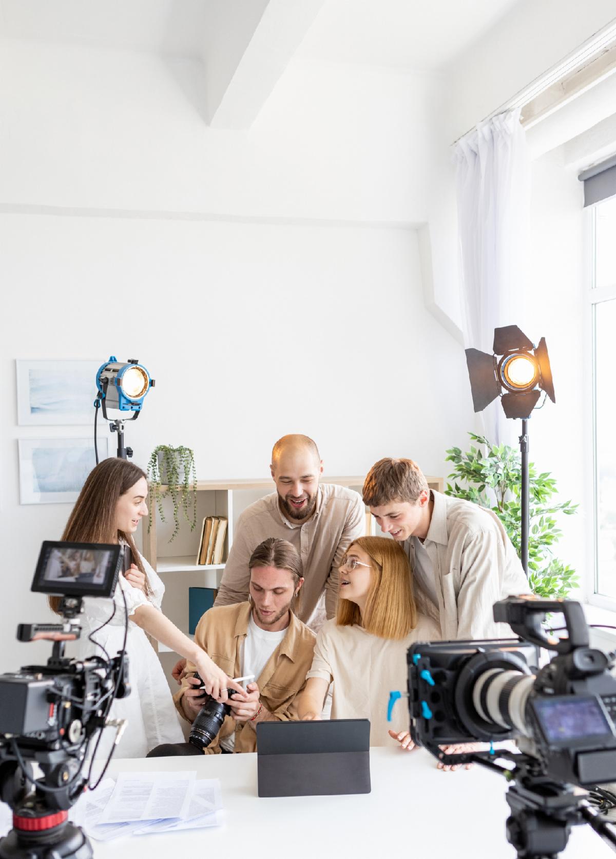 Photo review. Team explain. Men women tracking finished session result in professional studio. Colleagues emotionally discuss shooting project.