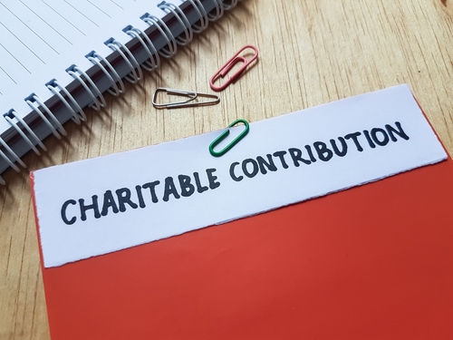 Charitable contribution writting on table background.