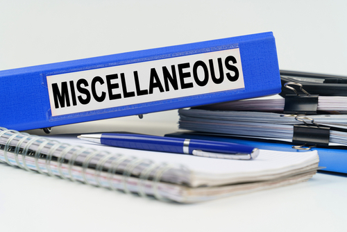 Business and finance concept. On the table are a notebook_ a pen_ documents and a folder with the inscription - MISCELLANEOUS