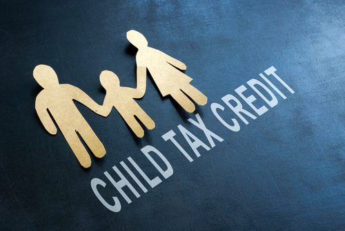Paper family and words child tax credit on the blackboard.
