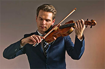 Mads Tolling playing violin