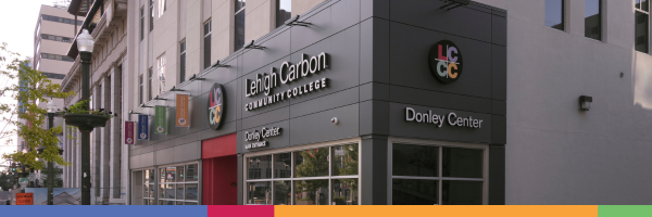 Exterior photo of the Lehigh Carbon Community College Donley Center building in downtown Allentown, featuring large glass windows, dark siding, and the college logo displayed on the facade.