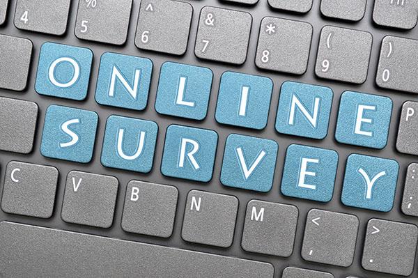 computer keyboard with blue keys that spell online survey