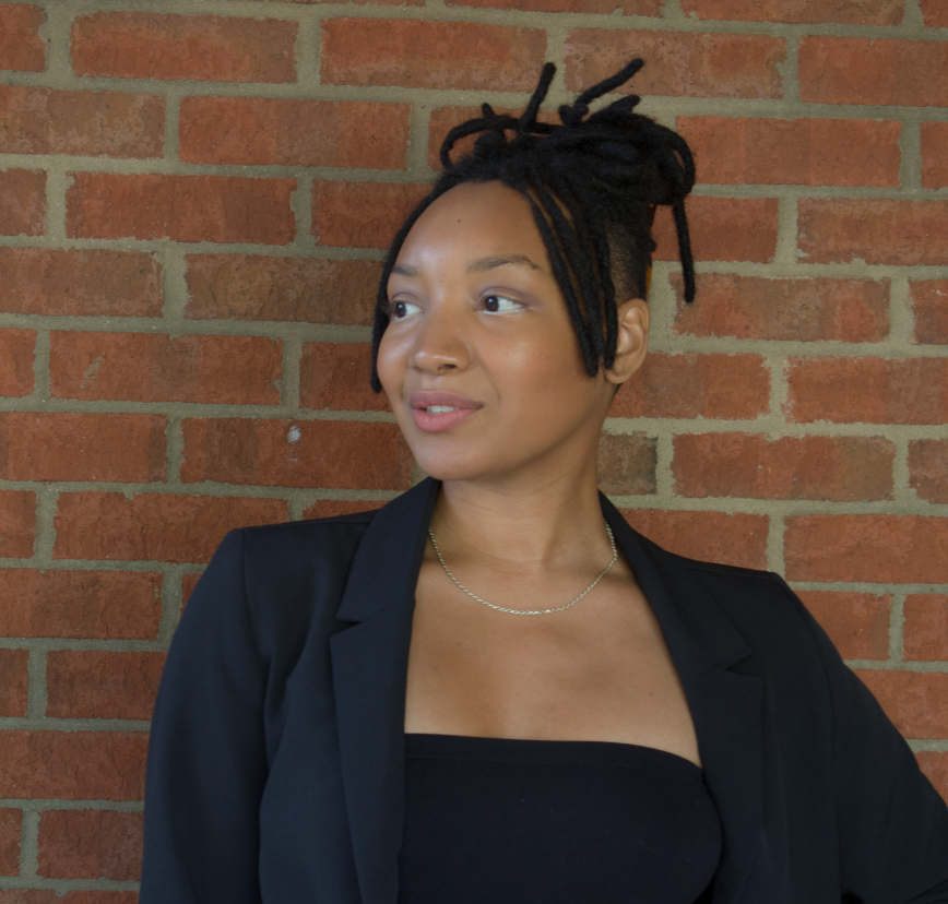 a headshot of a person with short brown hair