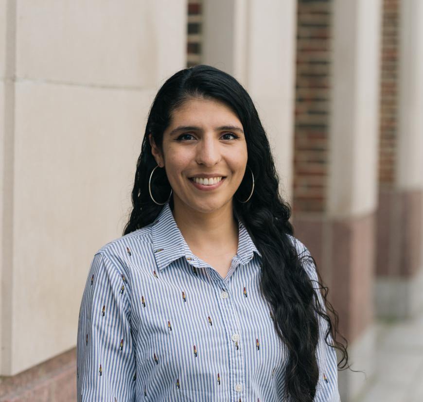 a headshot of a person with long brown hair