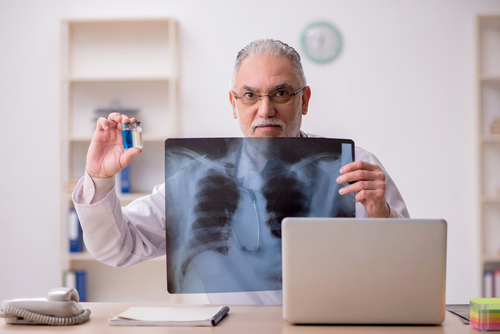 Old male doctor radiologist working in the clinic