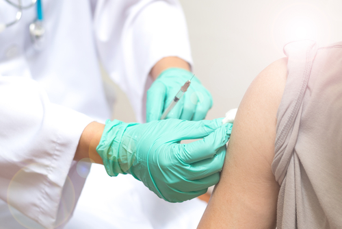 Vaccination healthcare concept. Hands of doctor or nurse in medical glov...