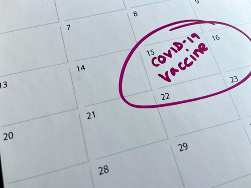 covid-19 coronavirus vaccine shot appointment calendar background with c...