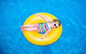Cute Little Girl Floating in Pool