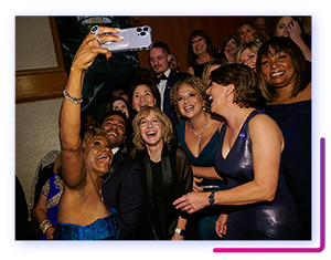 A group of attendees in formal wear take a selfie during 2022 Catalyst Awards.