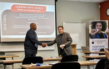Mayor Tyrone Garner shakes hands with gentleman from the Voters Network