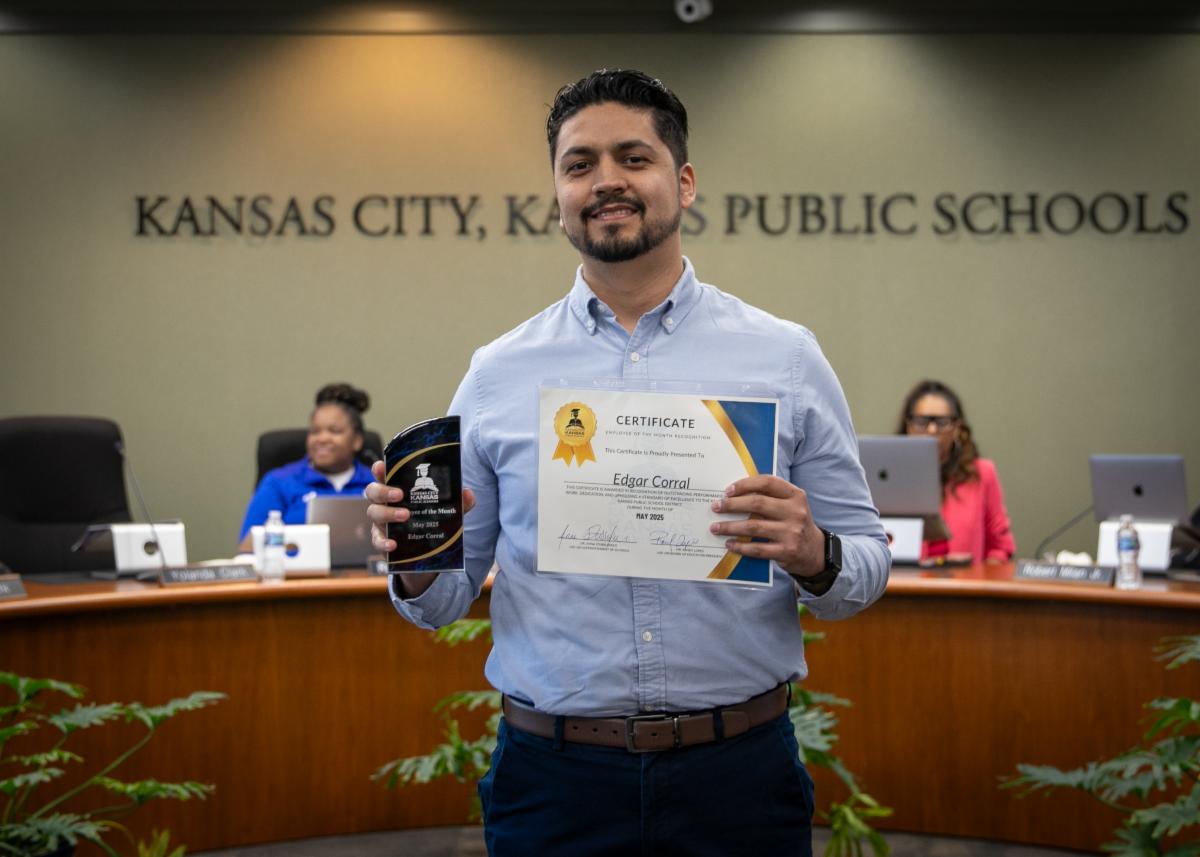 Edgar Coral poses for photo at school board meeting for being Employee of the Month