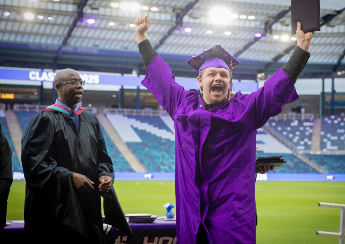 A 2025 graduation student from JC Harmon celebrates wildly at Sporting KC Arena  