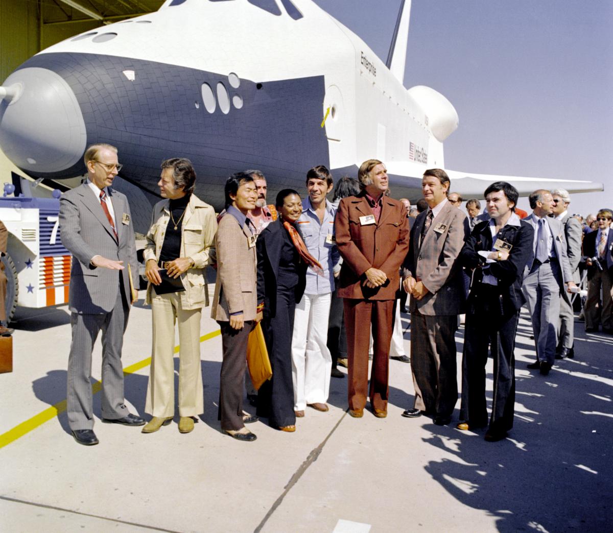 Gene Roddenberry and numerous Star Trek cast members appear in front of Space Shuttle Enterprise during it official rollout ceremony