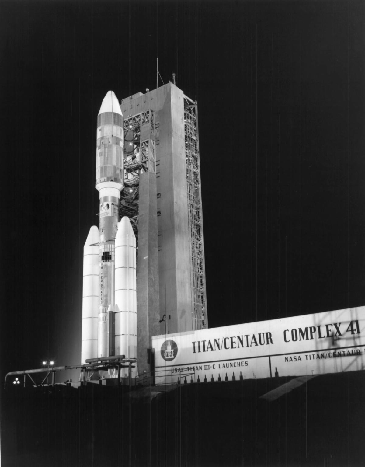 The Titan IIIE is lit up by lights at night as it sits on the launchpad at Cape Canaveral Air Force base in preparation for launch.