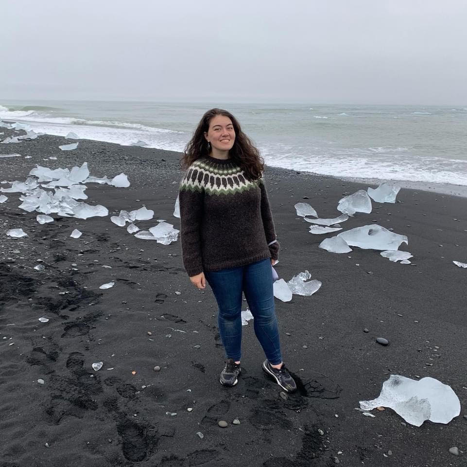 Portrait of Hannah Kaufman on a beach in Iceland