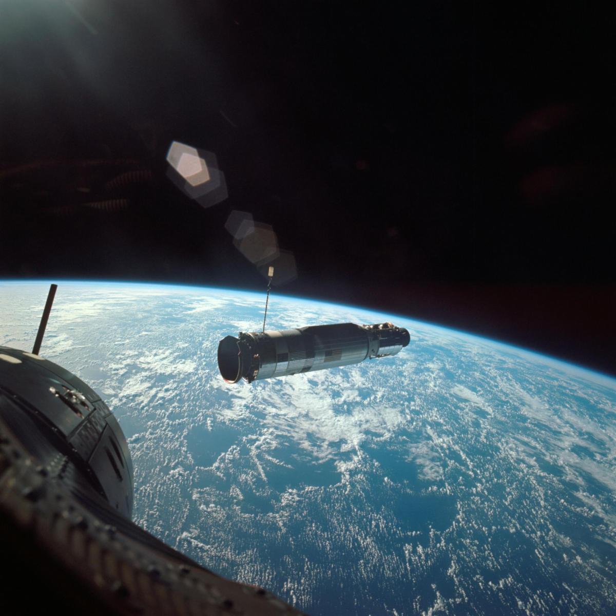 View from the Gemini X window showing Earth's limb and the Agena target vehicle