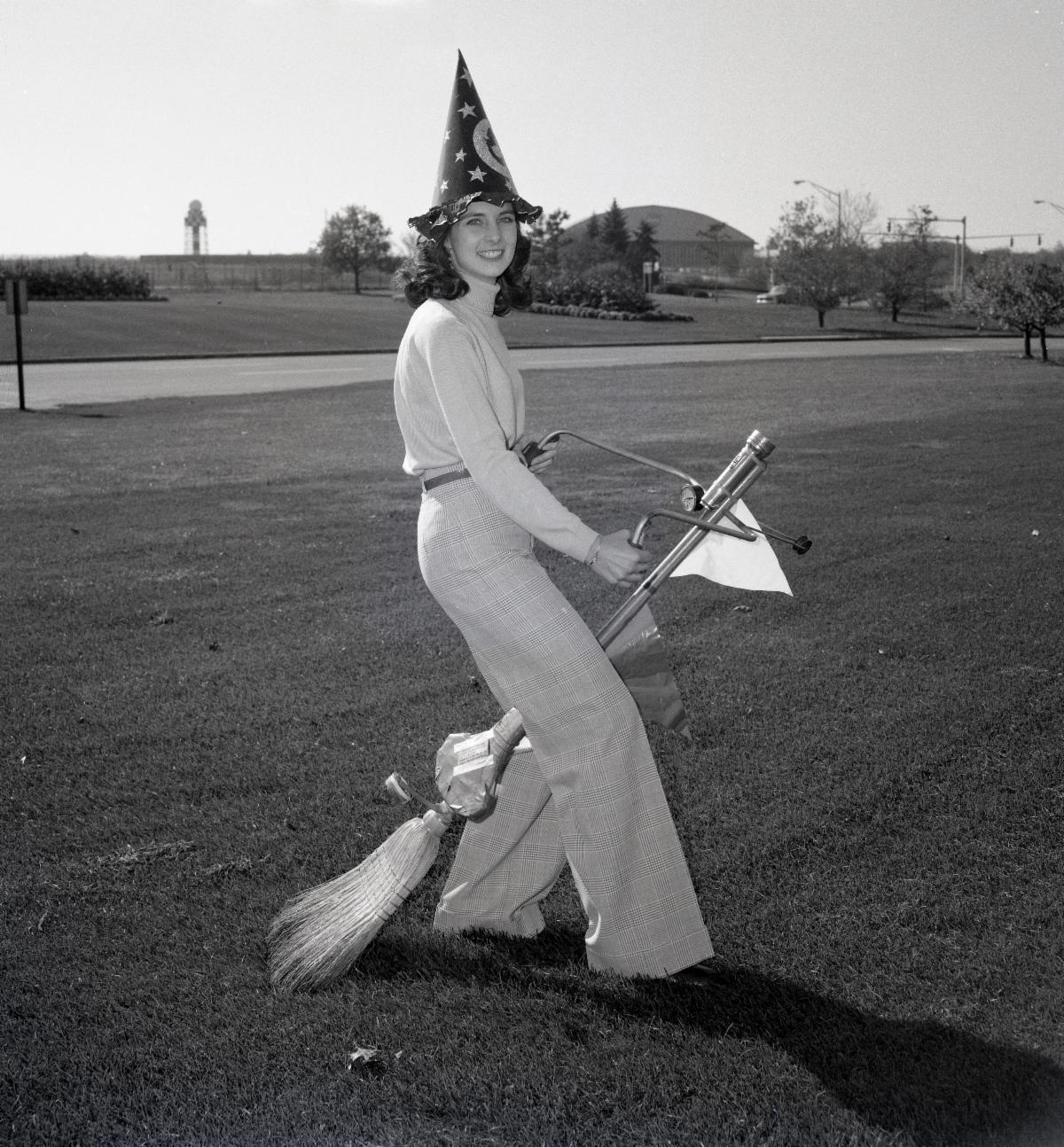 Mary Kathleen McGuirk, an employee at NASA Lewis Research Center (now known as NASA Glenn) wears a pointed hat and rides a space age broom for the centerâs Halloween celebration in 1977