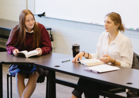 Faculty member leads students in seminar discussions.